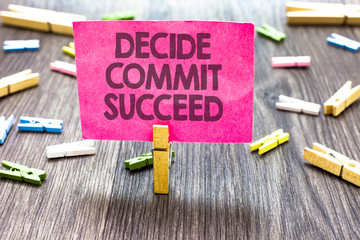 Writing note showing Decide Commit Succeed. Business photo showcasing achieving goal comes in three steps Reach your dreams Multiple clips woody table small card clipped notice announcement
