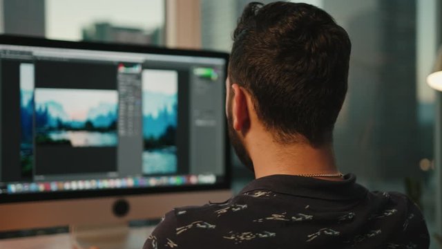 designer works on computer, dream workplace, view of Downtown LA, working corner, editing photos and videos