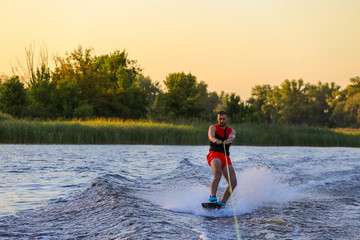 Man making waves on wakeboard 