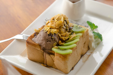 chocolate ice cream on honey toast with cereal and fruit