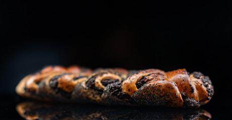 Pie with poppy seeds on a dark background.