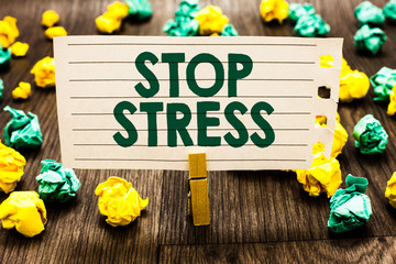 Text sign showing Stop Stress. Conceptual photo Seek help Take medicines Spend time with loveones Get more sleep Clothespin holding notebook paper crumpled papers several tries mistakes