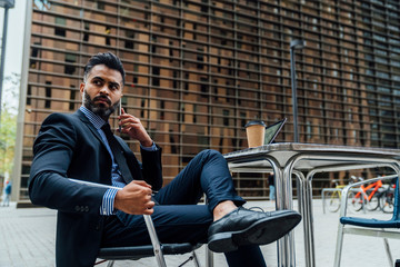 Young Indian Businessman on using a Mobile Phone in the City