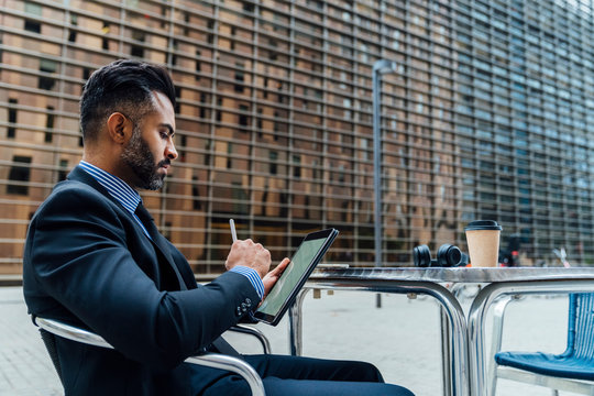 Adult Elegant Indian Businessman Signing a Contract or Taking a