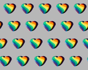 Rainbow-colored candy hearts patterned on grey