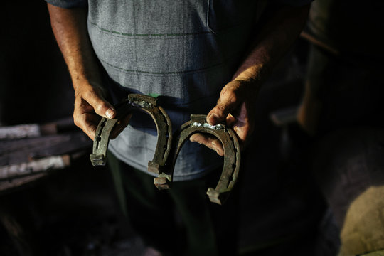 Blacksmith holds a horseshoe