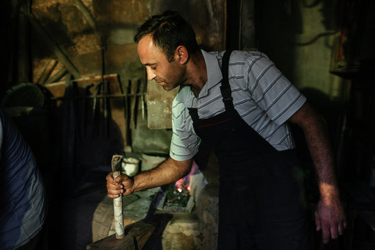 Blacksmiths working in a workshop