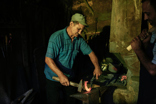 Blacksmiths working in a workshop
