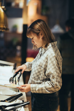 Young asian girl serving food at a buffet restaurant