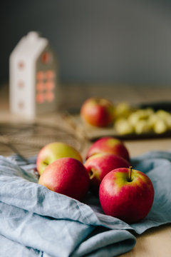 Cozy scene of apples being prepared for baking with candle house