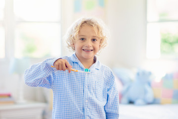 Child brushing teeth. Kids with toothpaste, brush.