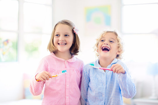 Child brushing teeth. Kids with toothpaste, brush.