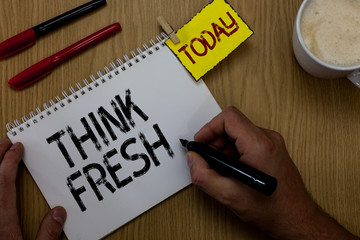 Handwriting text writing Think Fresh. Concept meaning Thinking on natural ingredients Positive good environment Man holding marker notebook clothespin reminder wooden table cup coffee
