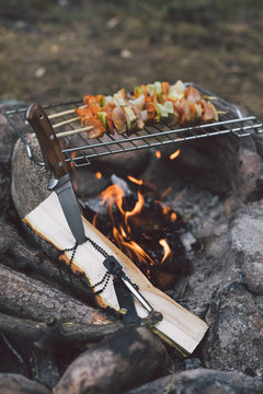 meat and vegetable skewers on open fire
