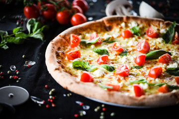 fresh italian pizza with mozzarella, cherry tomatoes & basil