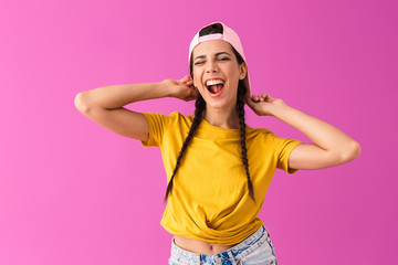 Photo of brunette joyful woman wearing cap backwards smiling and winking at camera