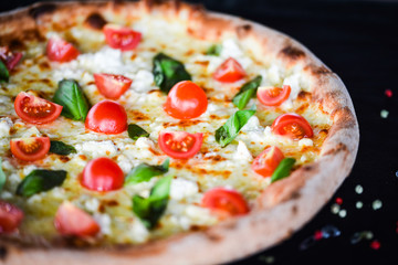 fresh italian pizza with mozzarella, cherry tomatoes & basil