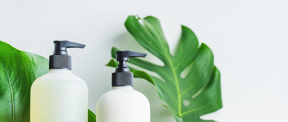 Cosmetic set of two blank label bottles for mockup packaging of skincare product cream, shampoo,...