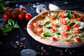 fresh italian pizza with mozzarella, cherry tomatoes & basil