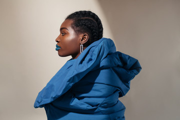 Fashionable black woman in blue coat