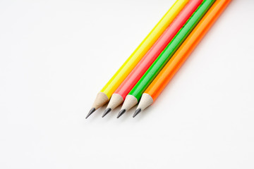 colored pencils in the shape of a star on a white background