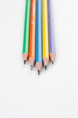 colored pencils in the shape of a star on a white background