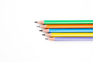 colored pencils in the shape of a star on a white background