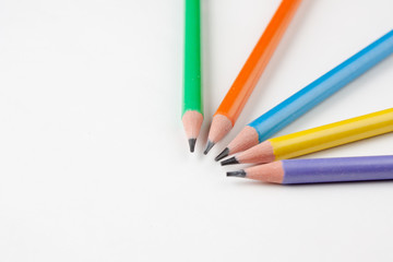 Fototapeta premium colored pencils in the shape of a star on a white background