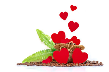 Valentine's Day concept. Heart papers on coffee burlap bag with green leave and coffee beens isolated white background. Copy space for text.
