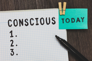 Writing note showing Conscious. Business photo showcasing aware of and responding to ones surroundings using his senses Open notebook page pins holding reminder marker wooden background