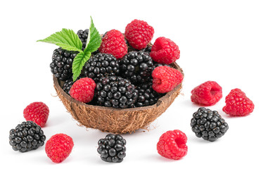 .raspberries and blackberries in a plate on a white background