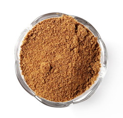 Coconut palm sugar in glass bowl isolated on white background, top view
