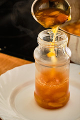 Fototapeta na wymiar Pouring marmalade in glass