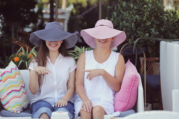 mom and daughter walk drinking coffee on a Sunny summer day
