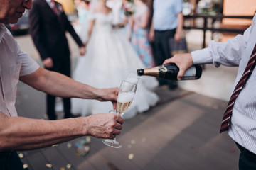 Fototapeta na wymiar a man pours champagne into a glass