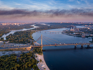 aerial night city view, luminous buildings and bridge. Drone shot.