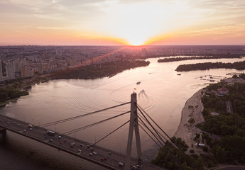 aerial night city view, luminous buildings and bridge. Drone shot.