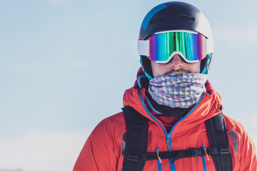 Man with ski goggles and skiing helmet in front of light background, Saalbach Hinterglemm, Pinzgau, Austria