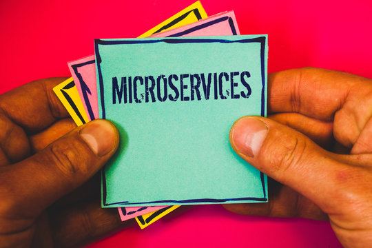 Writing note showing Microservices. Business photo showcasing Software development technique Decomposing an application Small multi colour notes hand border plane background remember card