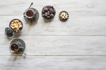 Tea with dates on a white wooden table. Top view with copy space