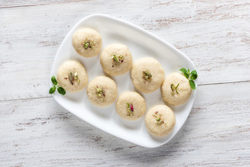 Peda (Indian sweet), Milk Fudge in a white wooden table. Top view