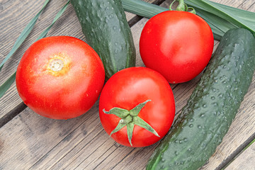 tomatoes and cucumbers on wooden background