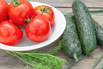 tomatoes and cucumbers on wooden background
