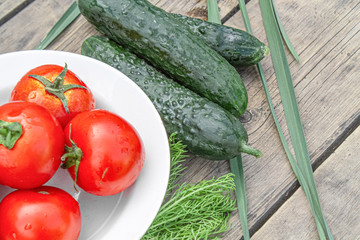 tomatoes and cucumbers on wooden background