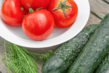 tomatoes and cucumbers on wooden background