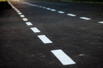 black asphalt road and white dividing lines