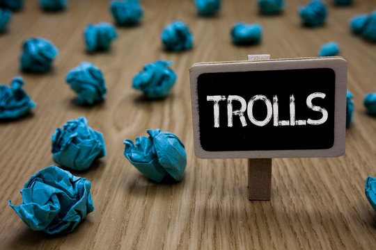 Writing note showing Trolls. Business photo showcasing Online troublemakers posting provocative inflammatory messages Cyan paper imagination idea crumpled papers mistakes several tries