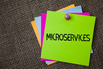 Handwriting text writing Microservices. Concept meaning Software development technique Decomposing an application Sticky cards board pinned muliple colours remember idea jute background