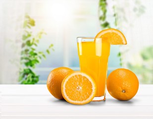 Orange juice and slices of orange on background