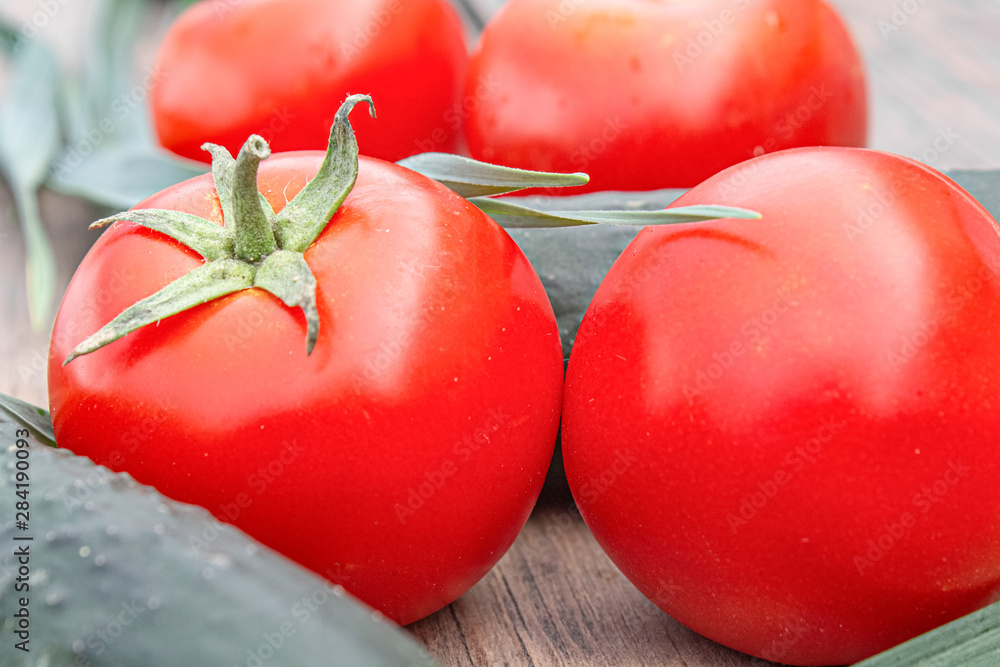 Wall mural tomatoes and cucumbers on wooden background